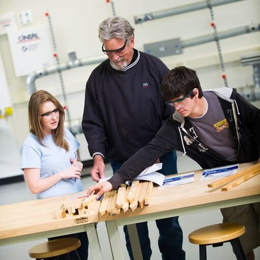 Professor helping students on engineering work
