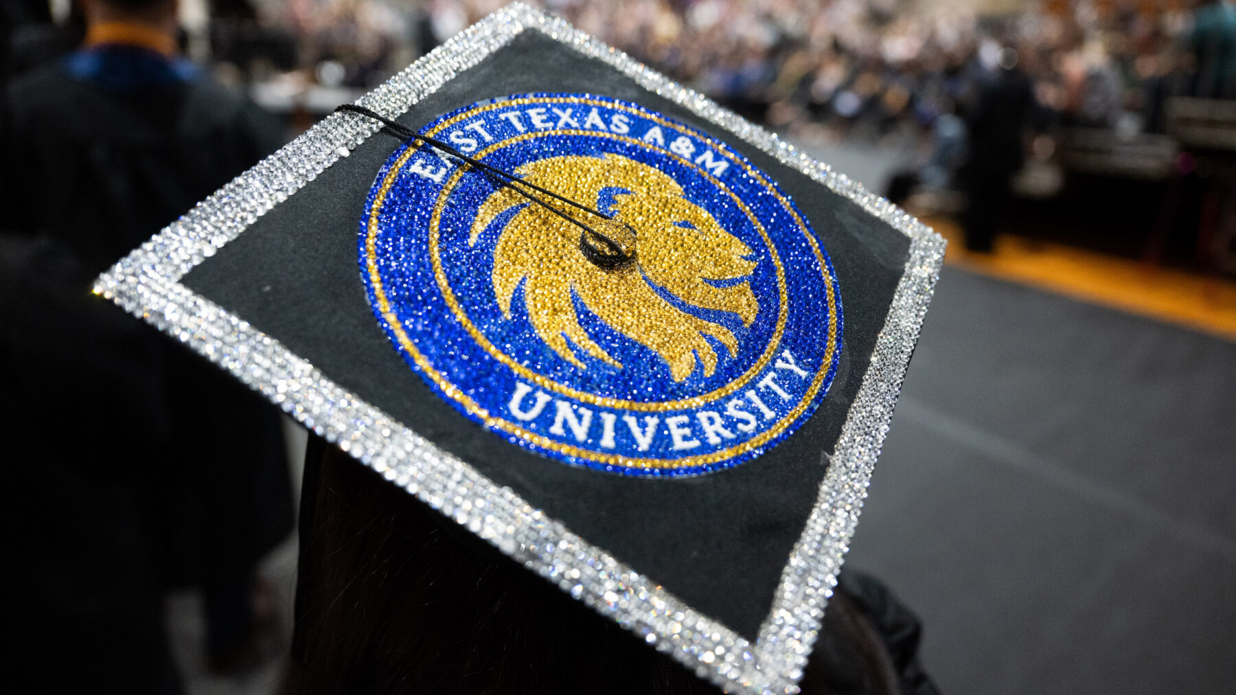 A decorated graduation cap featuring the logo of East Texas A&M University
