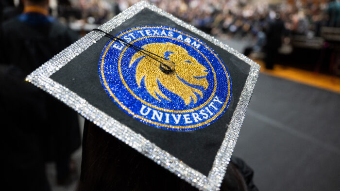 A decorated graduation cap featuring the logo of East Texas A&M University