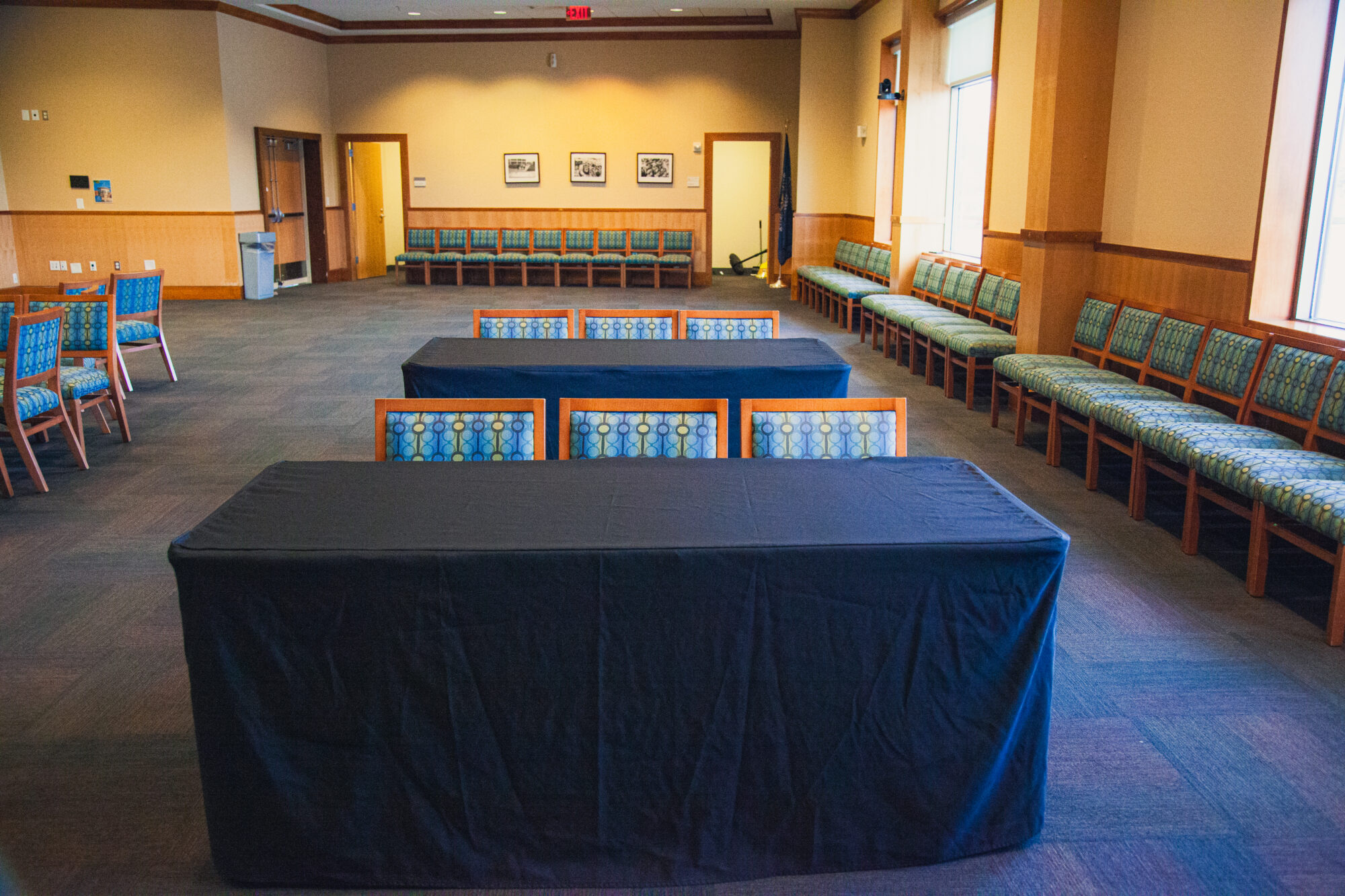 Tables and chairs are arranged in rows, all facing the same direction toward the front.
