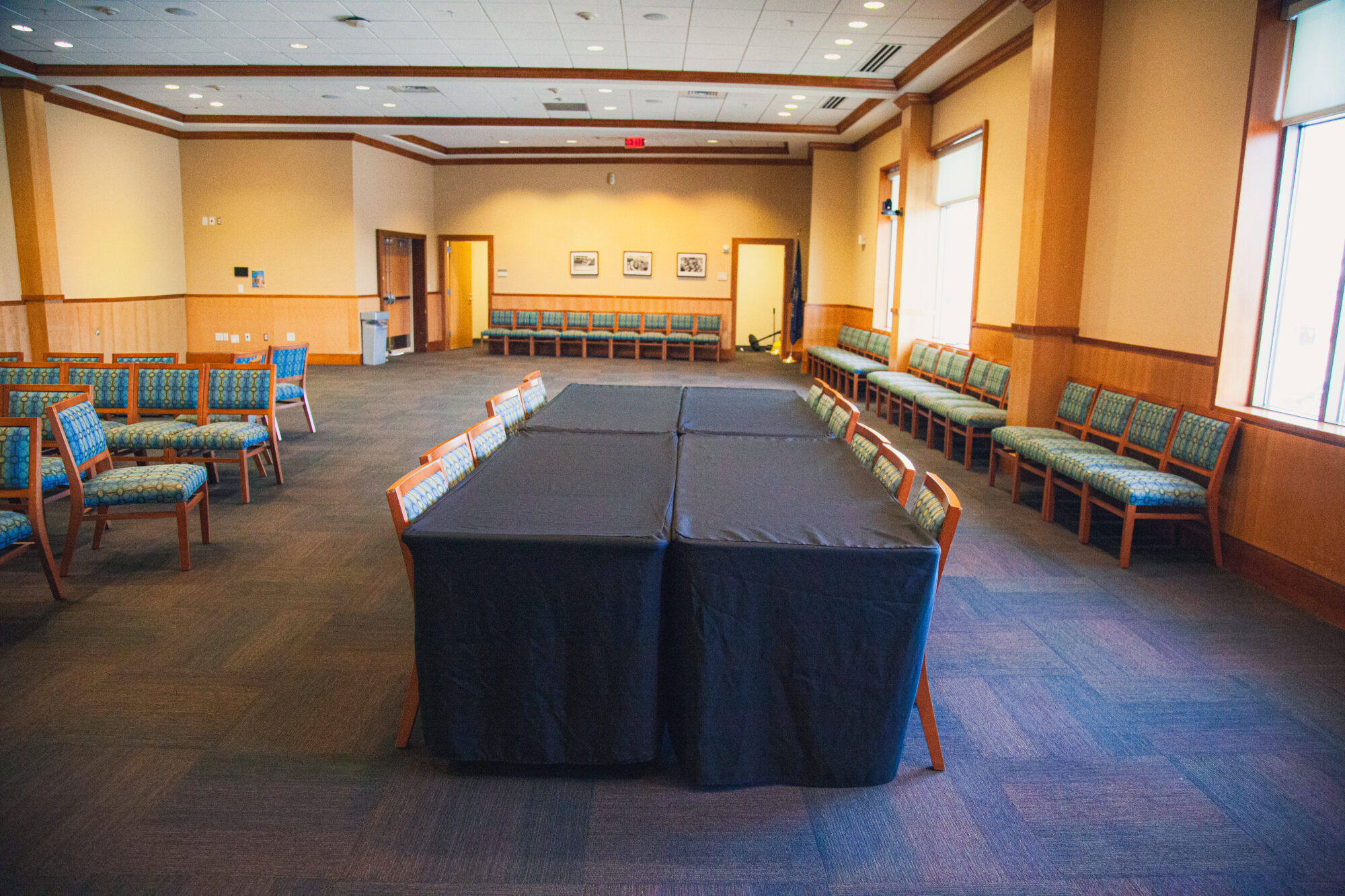 Tables and chairs are arranged in a square configuration.