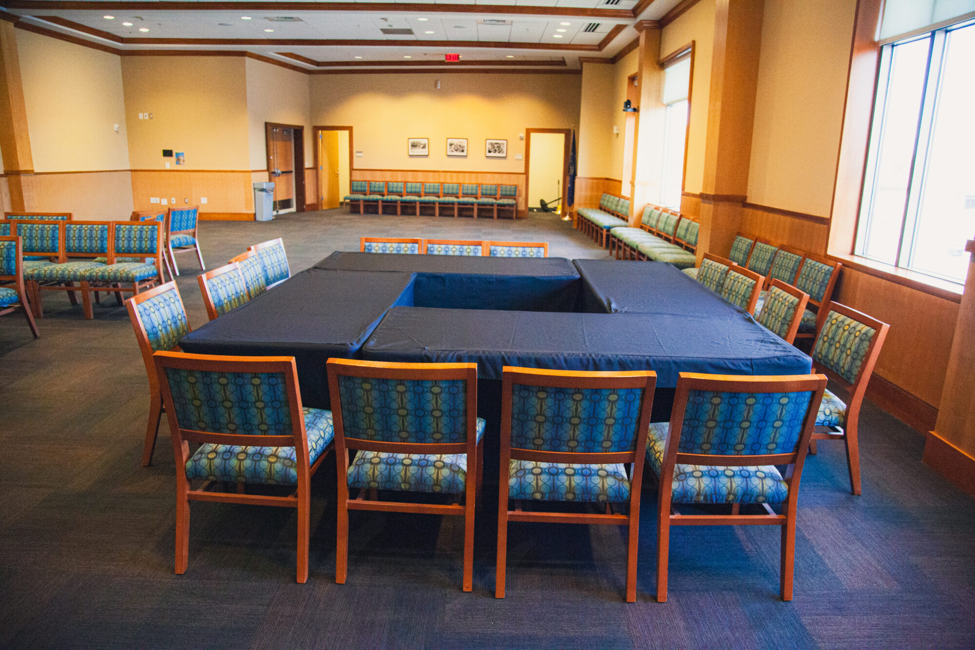 Tables and chairs are arranged in a square configuration.
