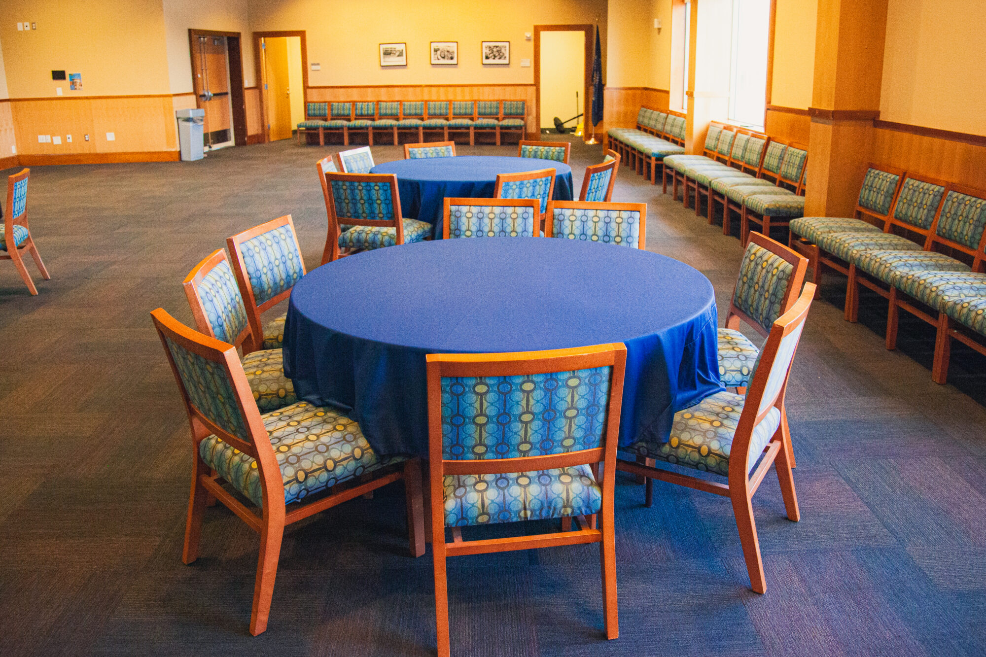 Eight chairs are arranged around each round table.