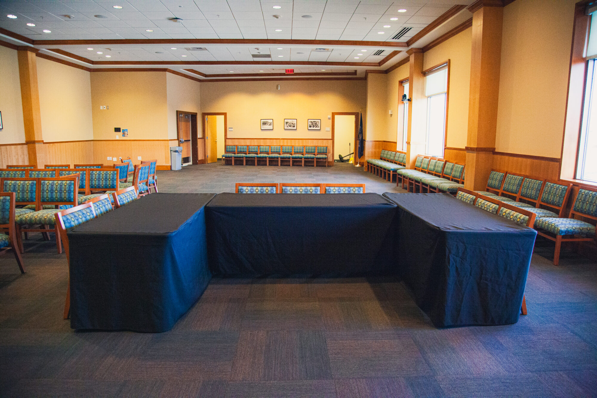 Tables and chairs are arranged in a U-shaped configuration.