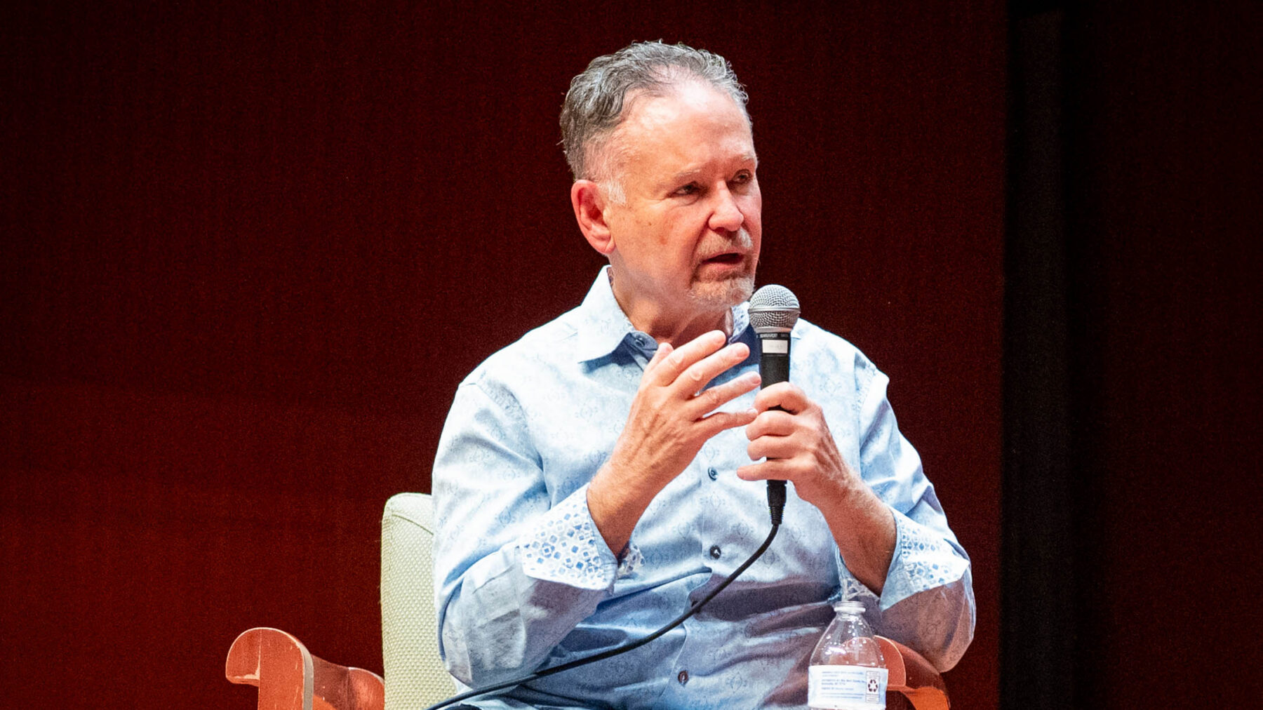 A person speaking into a microphone.