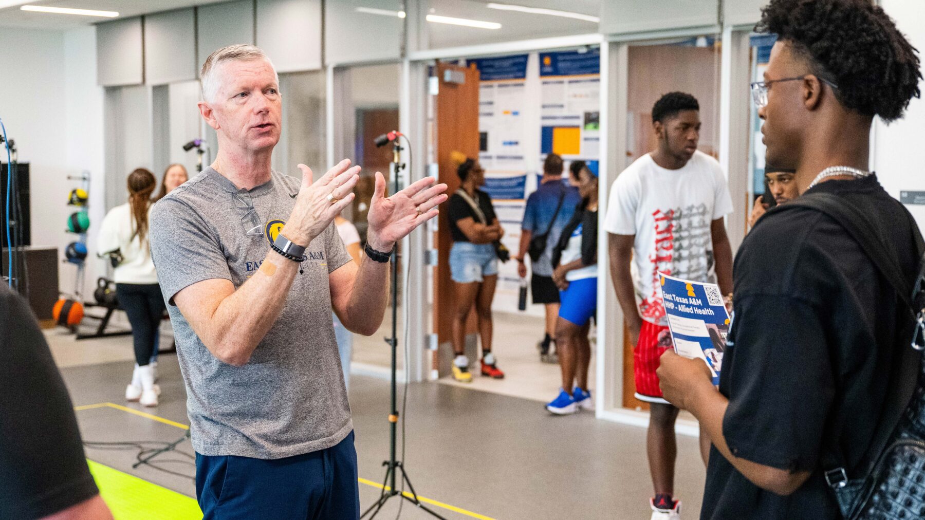 Two men standing and talking.