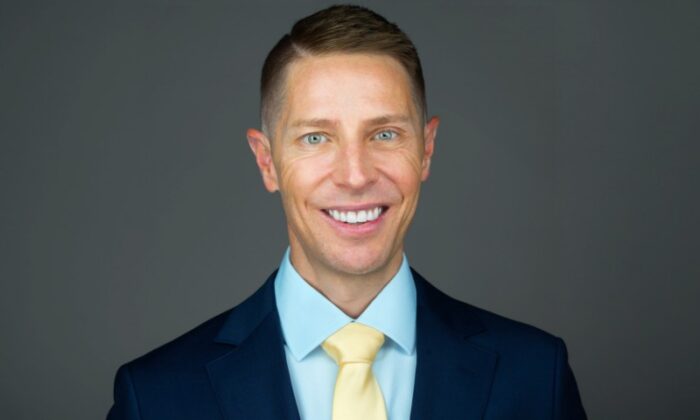 A headshot photo of a person in professional attire.