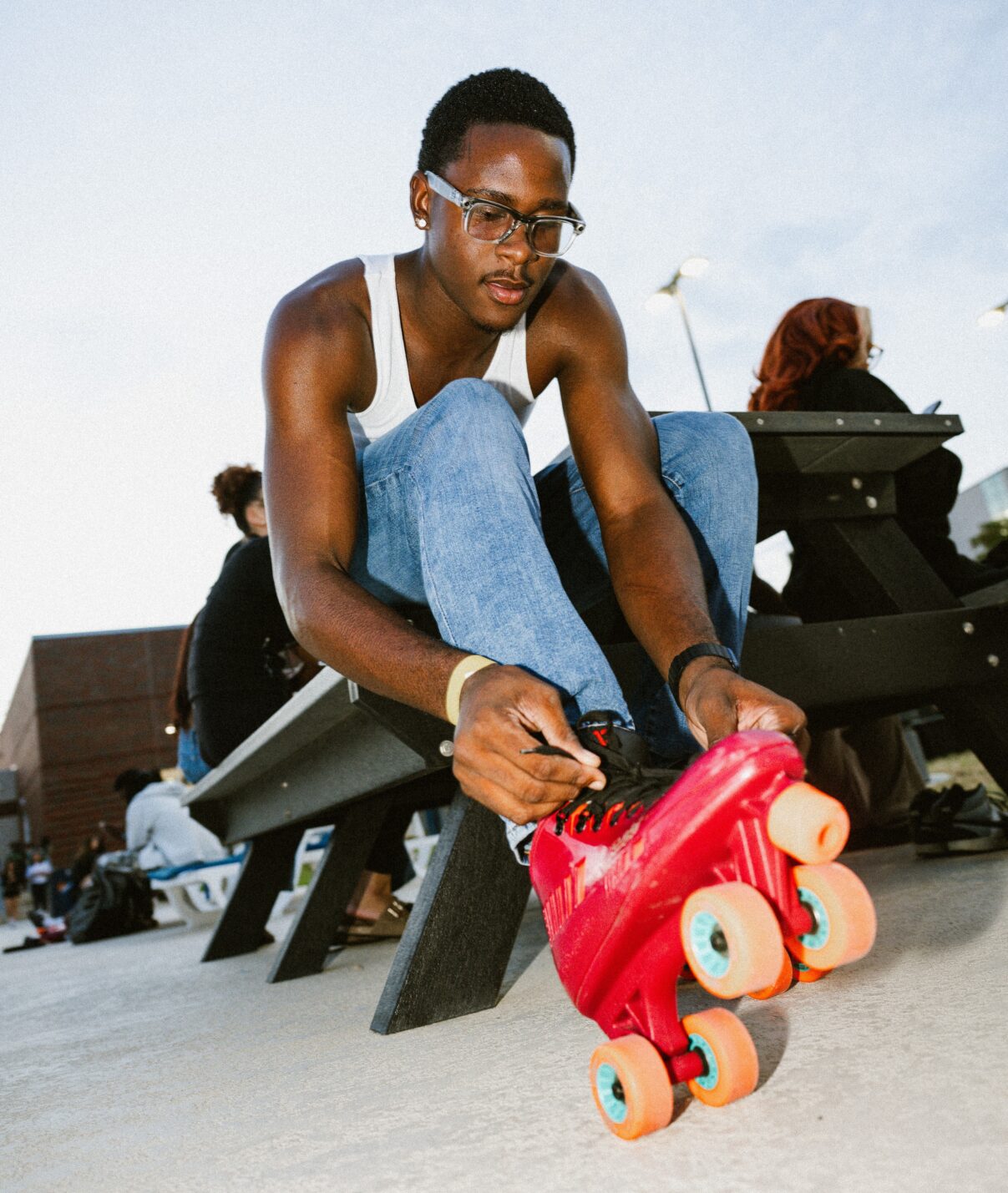 A person lacing up a pair of roller skates.